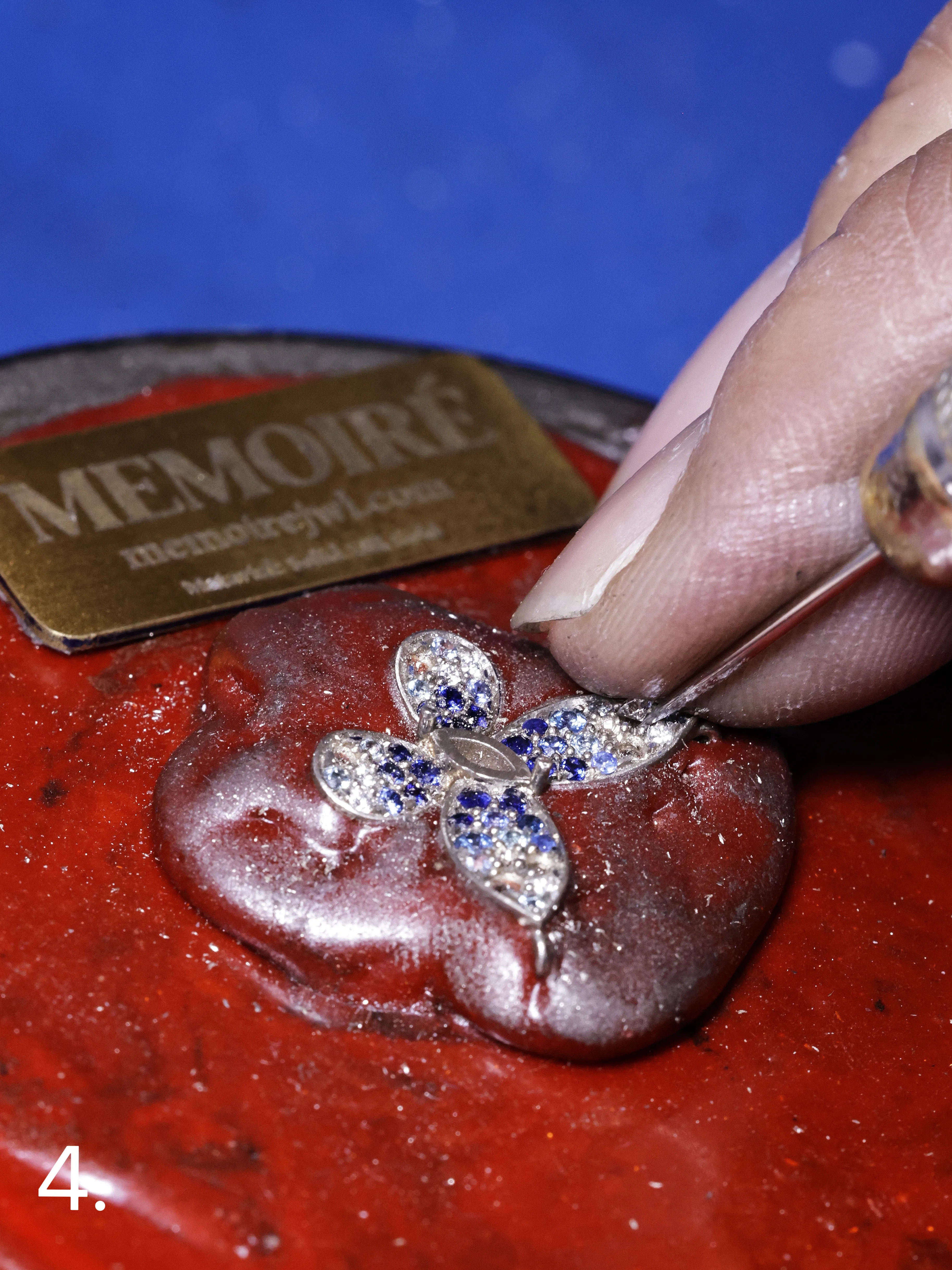Gemstones being hand-set into a jewelry mounting